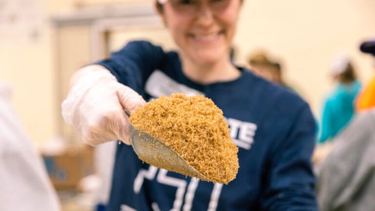 Blessings of Hope Volunteer scooping bulk food product